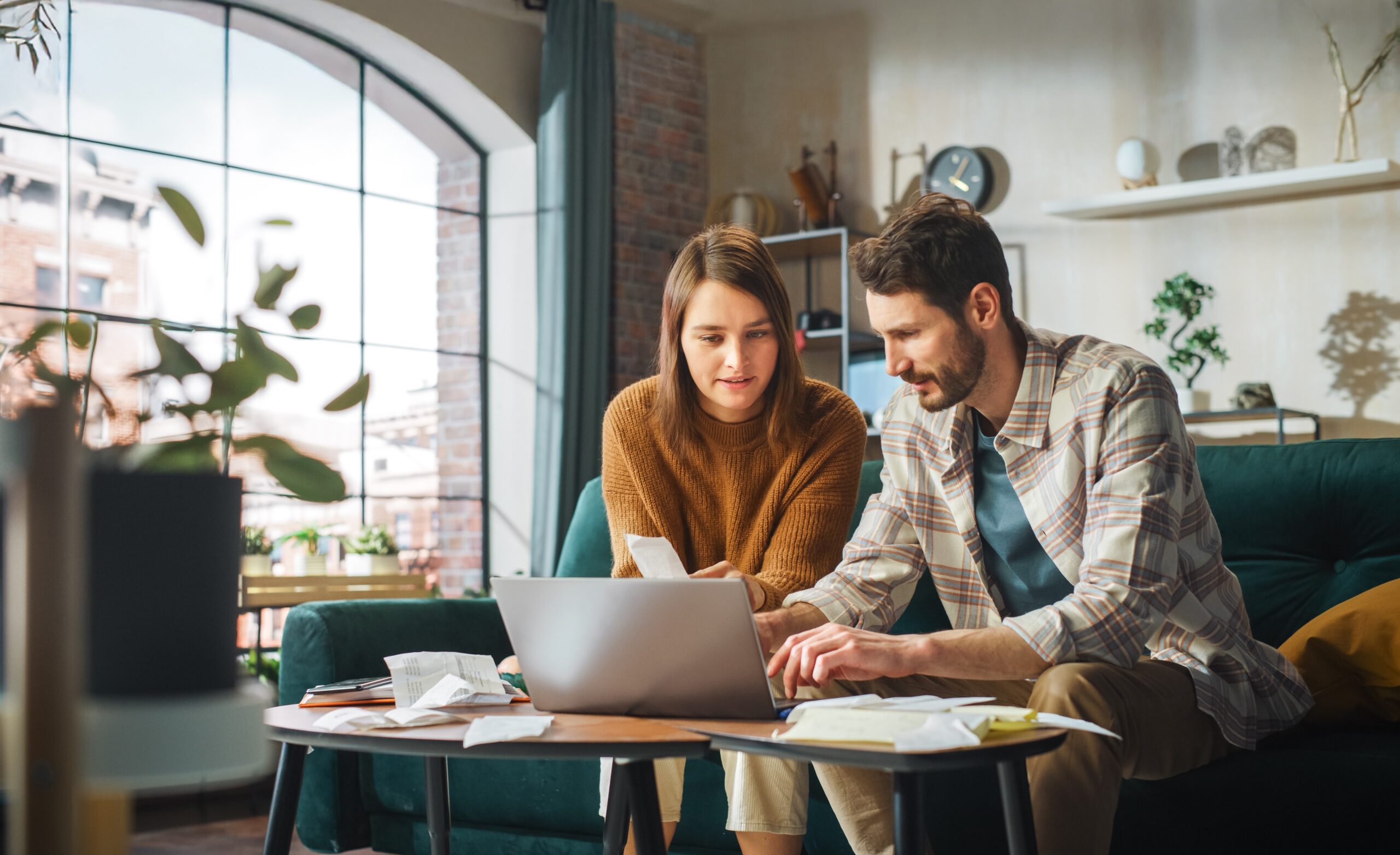 Couple sitting at computer looking over finances.